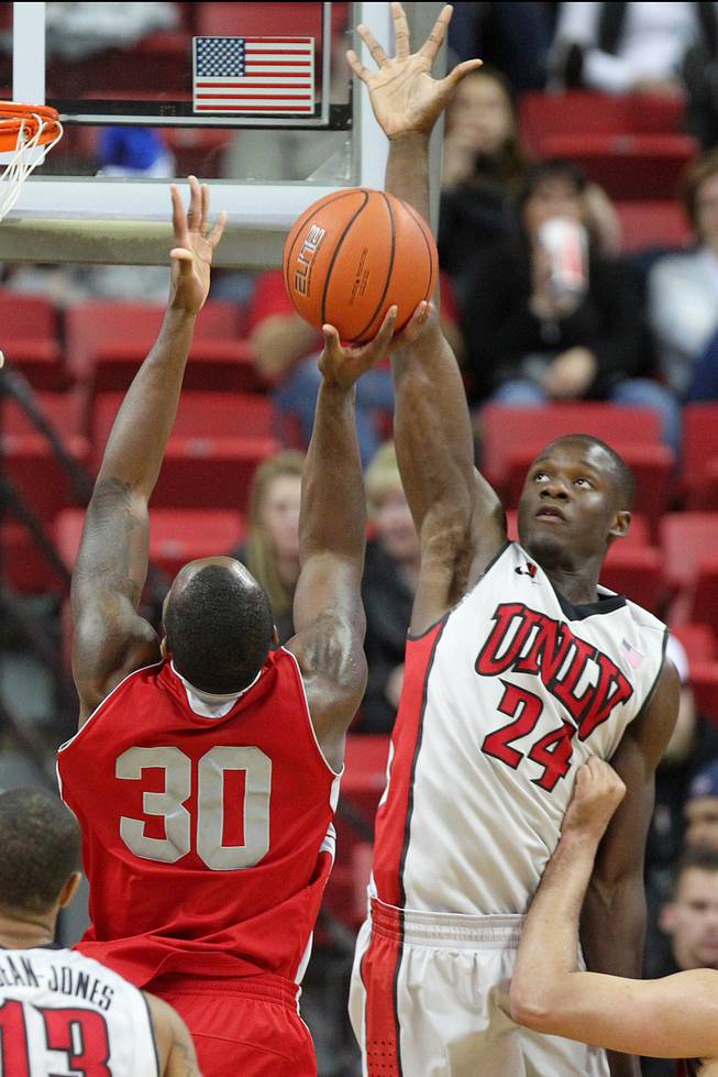 UNLV forward Demetris Morant leaps for one of his blocks as Sacred Heart forward Eyimofe Edukugho tries to shoot during their game Friday, Dec. 20, 2013 at the Thomas & Mack Center. UNLV won the game 82-50.